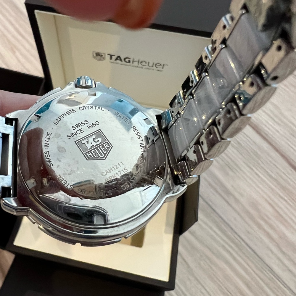 White ceramic tag heuer with diamonds on face.